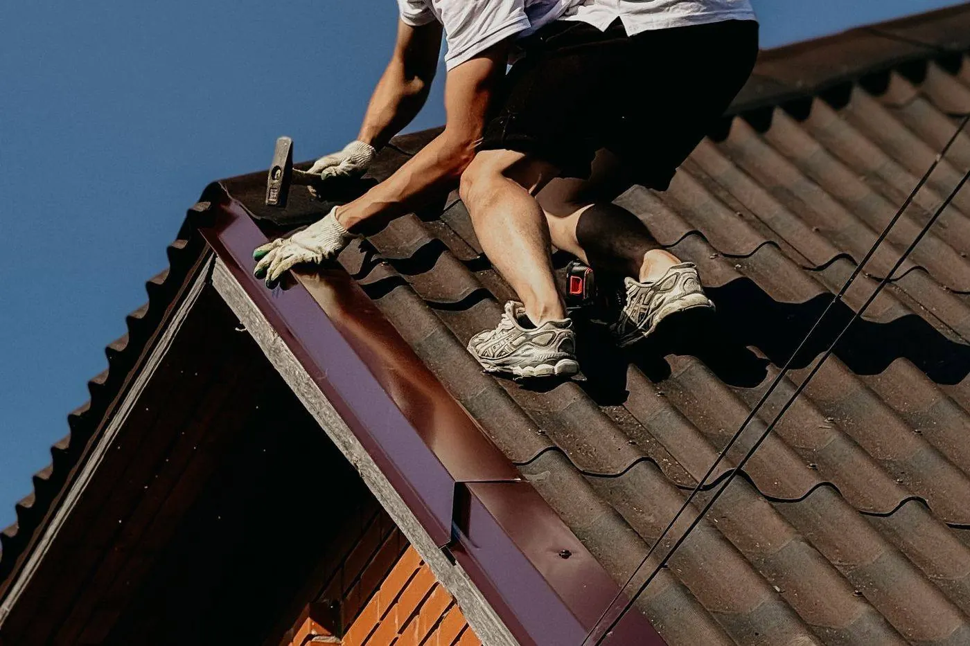 Roofer repairing roof flashing on a Sayreville home