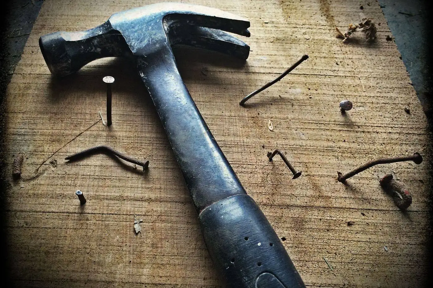 Hammer and roofing nails, proper fastening keeps shingle tabs flat and watertight