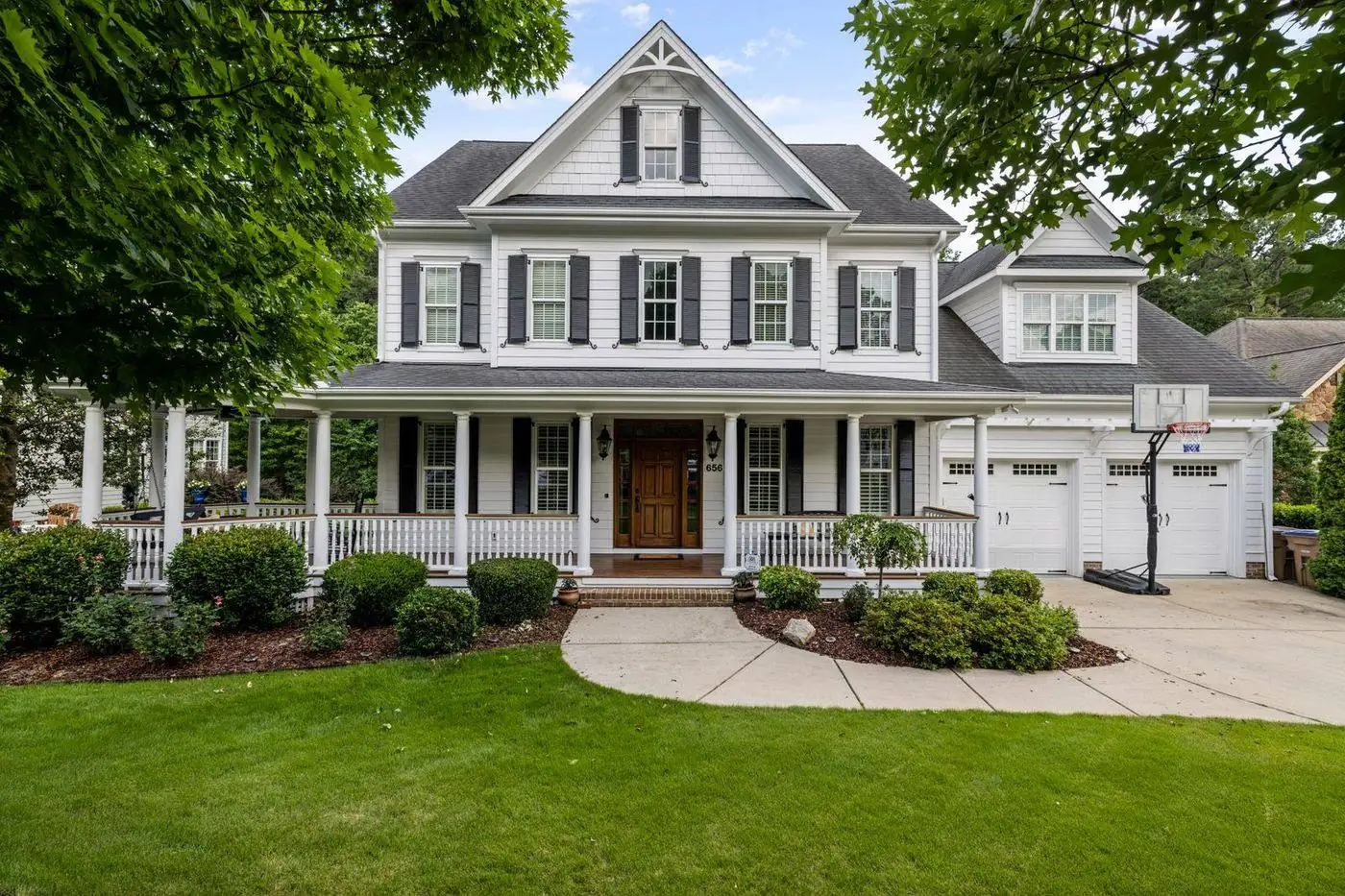 Two-story colonial suburban home with shingle roof and garage in Old Bridge, New Jersey