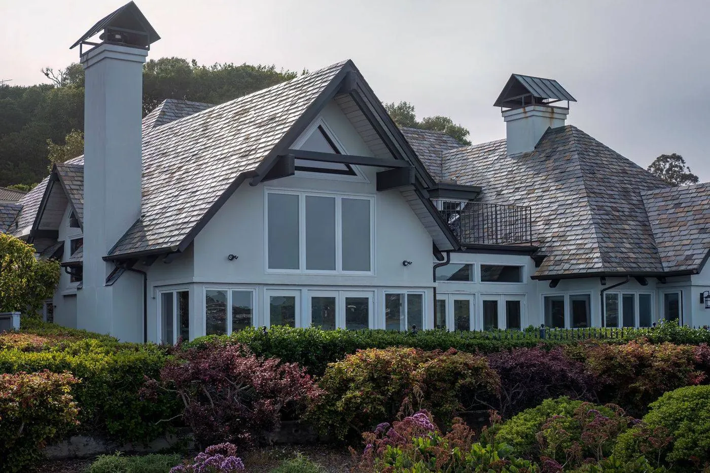 Steep-pitched aged shingle roof with chimney on a historic South Amboy home